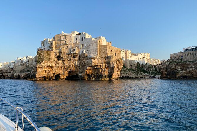 Boat excursion to Polignano a Mare between caves and coves - Stop 1: Statua di Domenico Modugno from the water