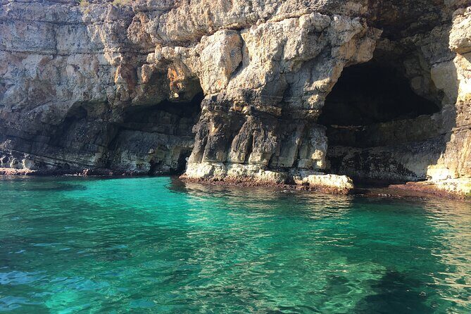 Polignano a Mare boat tour emotions, caves, diving and appetizers - The Grotta Azzurra stop: the light show you came for